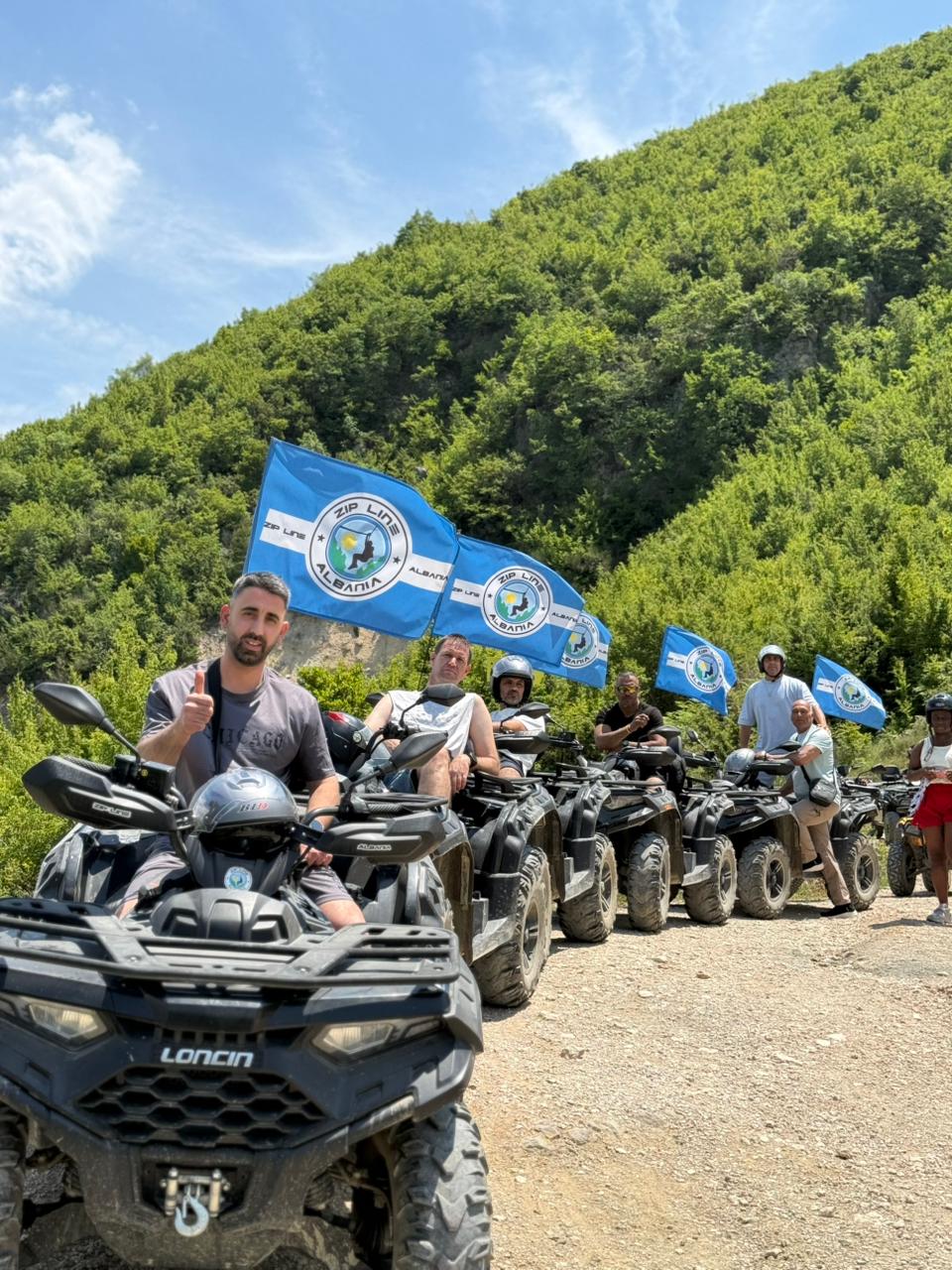 Group of riders with Zipline Albania flags